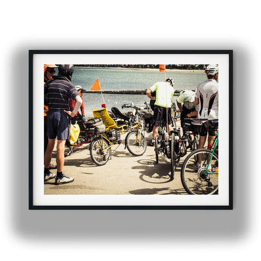 Bicycles and Riders Near Shoreline photo print